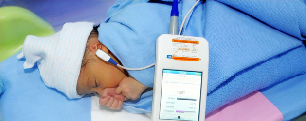 a newborn is gettimg the Hearing Screening with an  Echo-screen machine