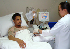 A health care worker with a military blood donor