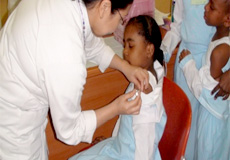 Nurse staff giving vaccine to a student
