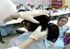 Nurse staff screening head for elementary student