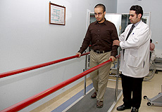 a physiotherapist assisting a patient walking
