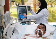 nure checking a Artificial ventilation machine hooked to a patient