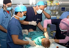 a team of Anesthesiologist in an operating room sedating a baby