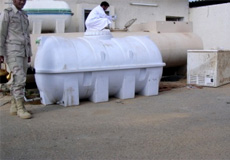 Employee checking water tanks condition